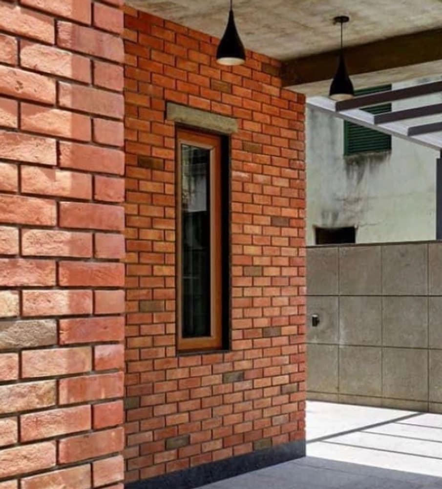 Decorative red terracotta brick tiles installed on an architectural feature wall with clean mortar pointing